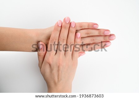 Beauty and skin care concept - female hand with pastel manicure isolated on white background. High quality photo