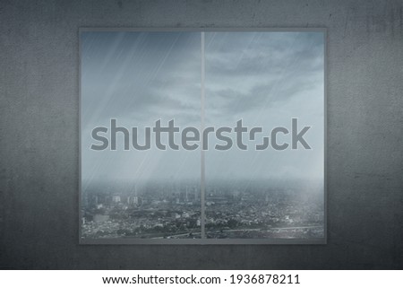 Window glass with view of urban life with rain and dark cloud background