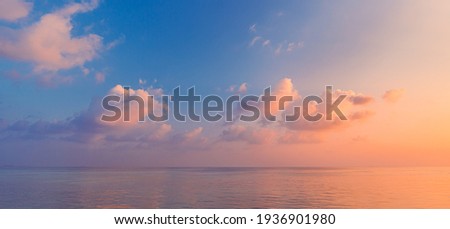 Sea ocean horizon. Skyscape with seascape. Orange and golden sunset sky, soft sand, calmness, tranquil relaxing sunlight, summer mood. Inspirational nature view, wide horizon of the sky and the sea Royalty-Free Stock Photo #1936901980