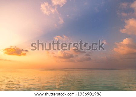 Sea ocean horizon. Skyscape with seascape. Orange and golden sunset sky, soft sand, calmness, tranquil relaxing sunlight, summer mood. Inspirational nature view, wide horizon of the sky and the sea Royalty-Free Stock Photo #1936901986