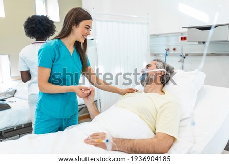 Healthcare concept of professional doctor consulting and comforting elderly patient in hospital bed or counsel diagnosis health. Medical doctor or nurse holding senior patient hands and comforting him Royalty-Free Stock Photo #1936904185