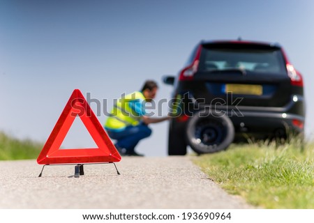 Car with problems and a red triangle to warn other road users Royalty-Free Stock Photo #193690964