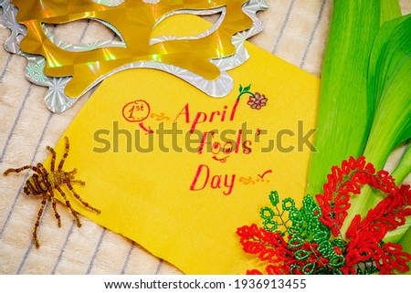 April Fools Day napkin with flowers and mask. 1st April. День Дурака надпись на бумаге