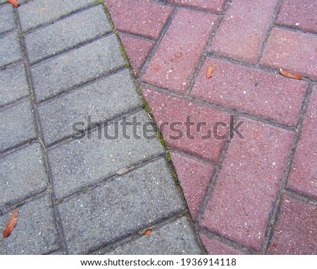 Combining rectangular paving tiles in different shades and paving patterns.