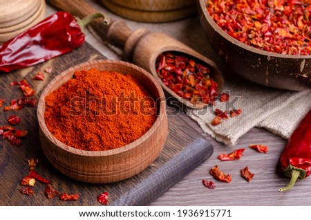 Red dried pepper on a dark wooden background. Selective focus. Royalty-Free Stock Photo #1936915771