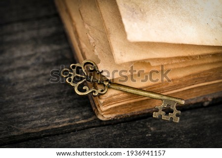 Retro Key And Opened Book On Wooden Table