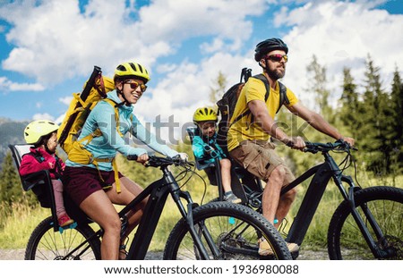 Family with small children cycling outdoors in summer nature, High Tatras in Slovakia. Royalty-Free Stock Photo #1936980088