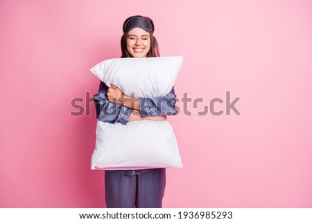 Photo portrait of cheerful woman hugging pillow with two hands isolated on pastel pink colored background Royalty-Free Stock Photo #1936985293