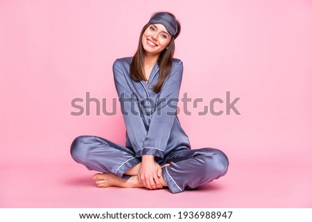 Full length photo portrait of cute girl sitting in lotus pose isolated on pastel pink colored background Royalty-Free Stock Photo #1936988947