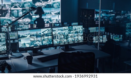 Two Digital Computer Screens with Surveillance CCTV Video in a Harbour Monitoring Center with Multiple Cameras on a Big Digital Screen. Employees Sit in Front of Displays with Big Data Royalty-Free Stock Photo #1936992931