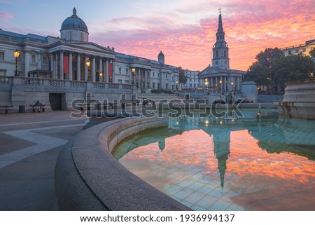 A vibrant colourful, dramatic sunrise or sunset sky at Trafalgar Square and the National Gallery in central London, UK. Royalty-Free Stock Photo #1936994137