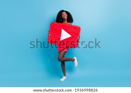 Photo of dreamy promoter lady hold play button pinata wear short dress footwear isolated blue color background