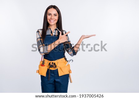 Photo of happy cheerful smiling woman in builder uniform advertising product object isolated on white color background