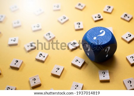 Question Mark on a dice and wooden alphabet tiles against yellow background. Concept of Choice,FAQ, Solution,Decision and luck Royalty-Free Stock Photo #1937014819