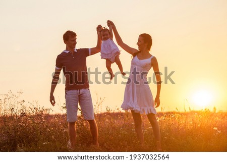 Mother, father and child daughter having fun outdoors. Royalty-Free Stock Photo #1937032564