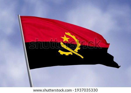Angola flag isolated on sky background. close up waving flag of Angola. flag symbols of Angola.