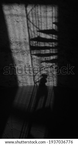 The shadow of a girl climbing the stairs to the tower