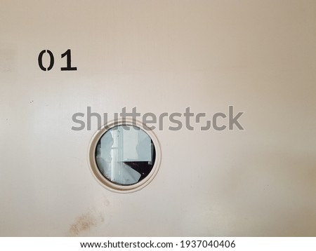 Circular window and number on ship