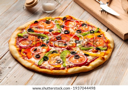 Side view on vegetable pizza with pepper and tomatoes 