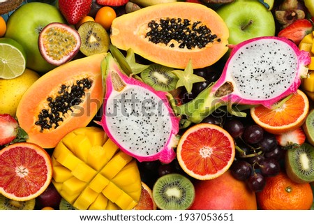 Many different delicious exotic fruits as background, top view Royalty-Free Stock Photo #1937053651