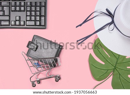 Flat lay collage of keyboard, cardholder in shopping cart, women’s hat, palm leaf and sunglasses isolated on pink background. Travel blog design. Top view, copy space