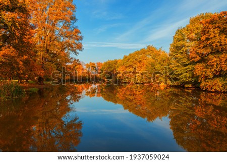 Landscape by the water. Stara Dyje river near Genoa castle in Czech republic. Trees are reflected in the river. Calm water. Colorful autumn. Beautiful clouds in the sky. Royalty-Free Stock Photo #1937059024
