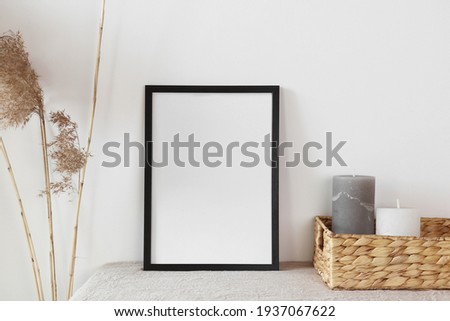 Black frame with candle and cane