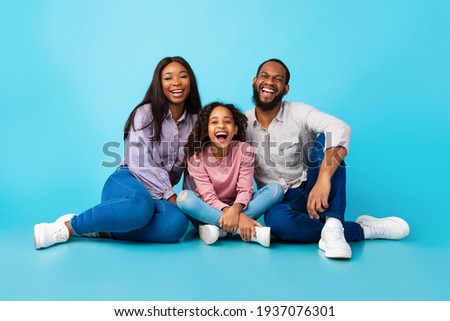 African American girl laughing with her mom and dad