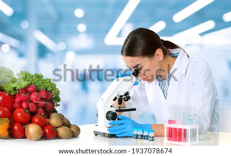Quality control specialist inspecting food in laboratory Royalty-Free Stock Photo #1937078674