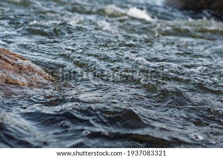 Background, top view, rapid flow river with dark blue water and white foam waves