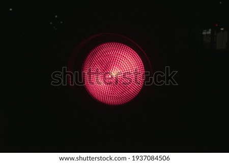 red circle traffic lamp with dark street for the background in cross road