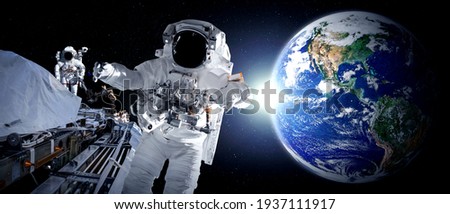 Astronaut spaceman do spacewalk while working for space station in outer space . Astronaut wear full spacesuit for space operation . Elements of this image furnished by NASA space astronaut photos. Royalty-Free Stock Photo #1937111917
