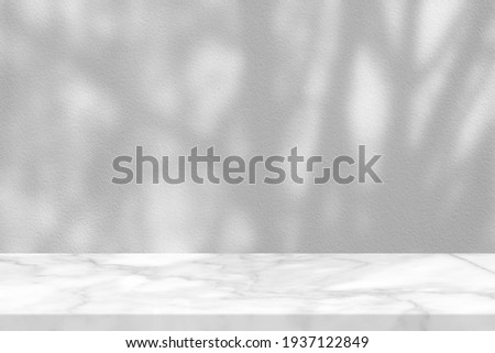 White Marble Table with Tree Branches Shadow on Concrete Wall Texture Background, Suitable for Product Presentation Backdrop, Display, and Mock up. Royalty-Free Stock Photo #1937122849