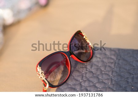 Sunglasses red model for women with a special design shoot outside in nature in a summer day . Selective focus 