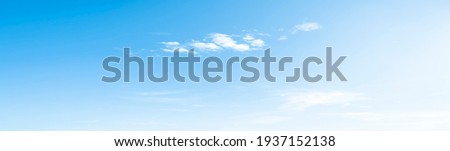 Blue sky and white clouds floated in the sky on a clear day with warm sunshine combined with cool breeze blowing against the body resulting in a miraculous refreshing like paradise. Royalty-Free Stock Photo #1937152138