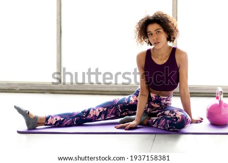 Young sporty woman is doing excercises and stretching