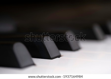 Black and white piano keys side view with shallow depth of field. The black keys are called sharps or flats.
Focus on the second black key from the left