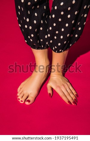 Polka-dot outfit. Bright fashionable hand and leg working up daily things together. Modern artwork, contemporary art. Trendy colors, magazine style. Usual routine in unusual way. Pink background.