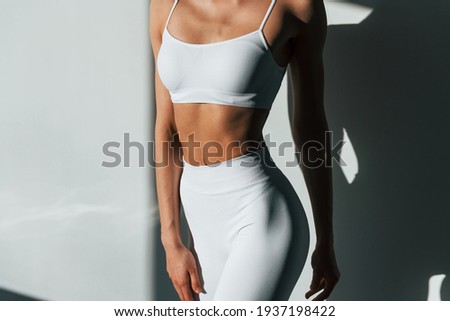 Beautiful lighting. Young caucasian woman with slim body shape is indoors at daytime. Royalty-Free Stock Photo #1937198422