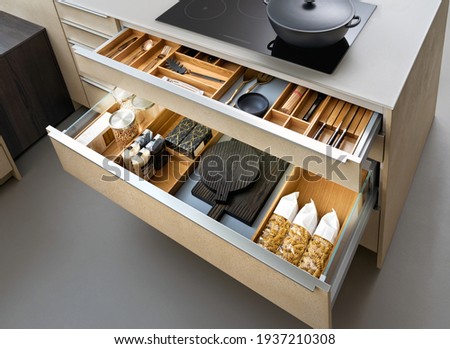 Modern kitchen, Open drawers, Set of cutlery trays in kitchen drawer. Solid oak wood cutlery drawer inserts. Royalty-Free Stock Photo #1937210308