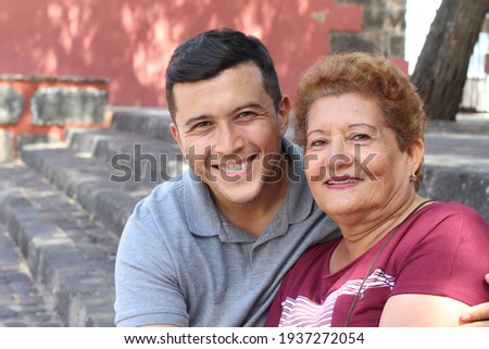 Single Hispanic mature mother with only one adult son Royalty-Free Stock Photo #1937272054
