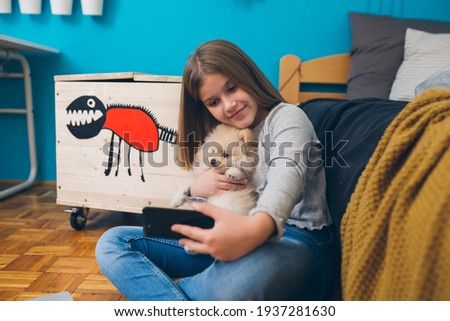 teenager girl with her puppy at home