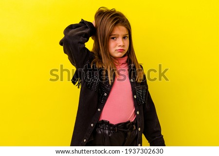 Little caucasian girl isolated on yellow background tired and very sleepy keeping hand on head.