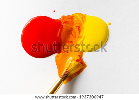 Red and Yellow Paint Making Orange