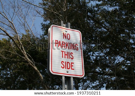 Road signs: No Parking This Side