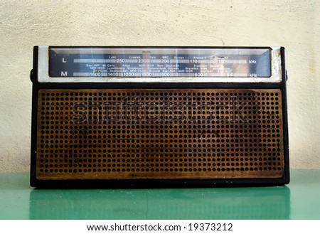Old mono radio transistor on green table
