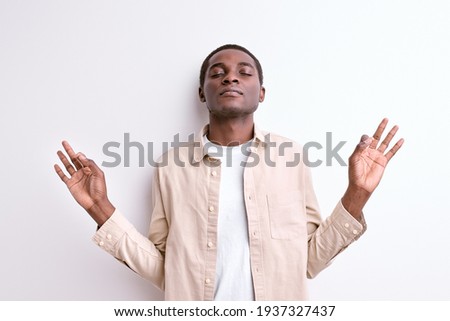 Calm black african male keep calm, meditating in yoga pose