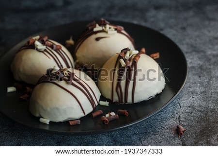 Delicious cakes on the table. Hemispherical cakes. White chocolate cakes