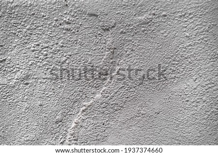 textured wall stucco background with scratches, scuffs and stains. uneven plaster backdrop of white and gray color for copy space