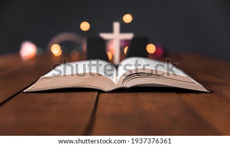  Holy Bible with cross on the bokeh background

